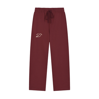 Dull red heavyweight pants with Auspex bird at the hip, front view