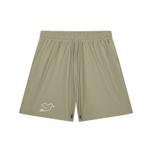 Khaki stretch shorts with Auspex bird on the leg, front view